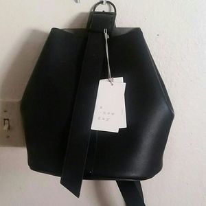 A. New. Day. Convertible bucket bag